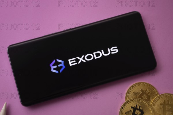 Dhaka, Bangladesh- 06 Sep 2025: Exodus logo on smartphone screen near Bitcoin coin and QR code on background