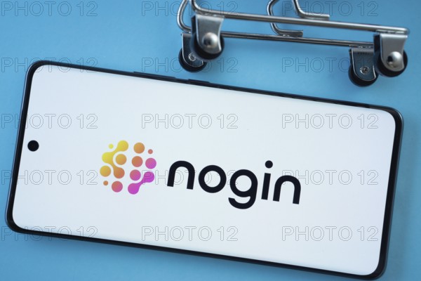 Dhaka, Bangladesh- 03 July 2025: Smartphone screen showing the nogin logo with shopping cart wheels on a blue background