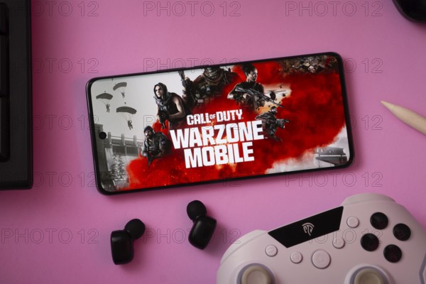 Dhaka, Bangladesh- 06 Sep 2025: A close-up of a gamepad with the Call of duty warzone mobile seen on smartphone