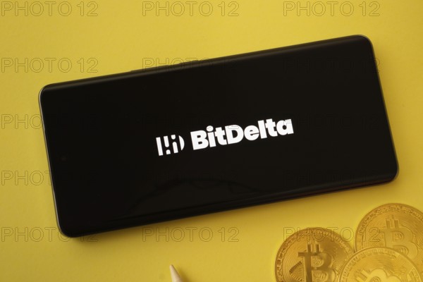 Dhaka, Bangladesh- 02 June 2025: BigDelta logo on smartphone screen near Bitcoin coin and QR code on background