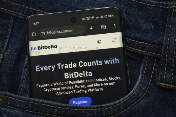 Dhaka, Bangladesh- 15 June 2025: A smartphone displaying the BitDelta.com web interface peeks out of a denim pocket