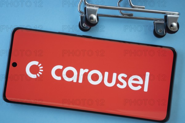 Dhaka, Bangladesh- 03 July 2025: Smartphone screen showing the Carousell logo with shopping cart wheels on a blue background
