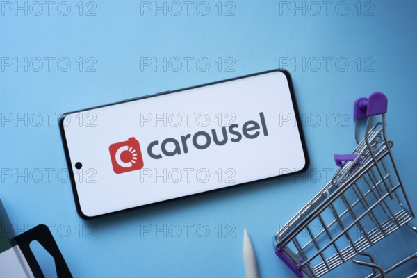 Dhaka, Bangladesh- 03 July 2025: Smartphone displaying Carousell logo with shopping cart on a blue background
