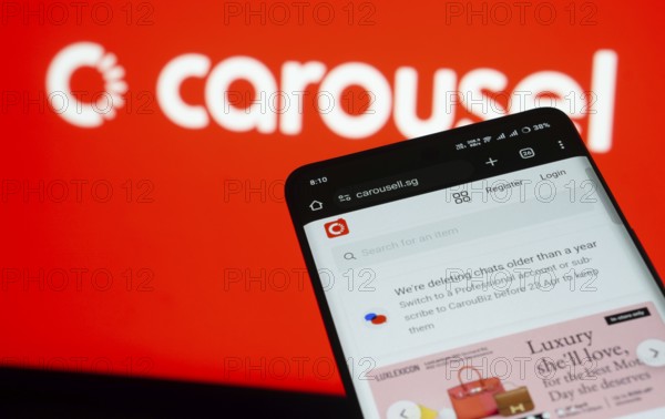 Dhaka, Bangladesh- 03 July 2025: Smartphone displaying Carousell web interface against carousel logo background