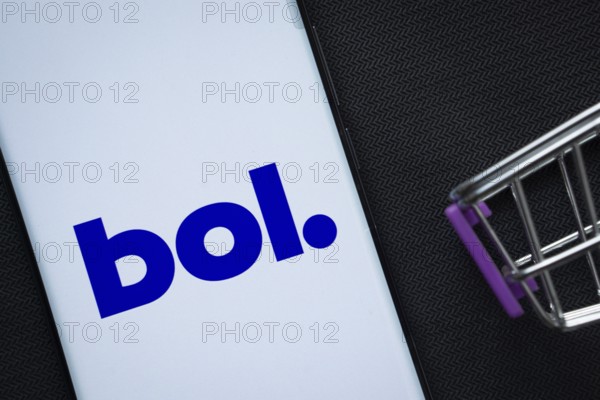 Dhaka, Bangladesh- 03 July 2025: A smartphone displaying the bol logo next to a miniature shopping cart on a background