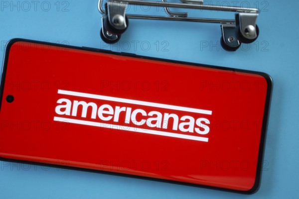 Dhaka, Bangladesh- 03 July 2025: Smartphone screen showing the Americanas logo with shopping cart wheels on a blue background