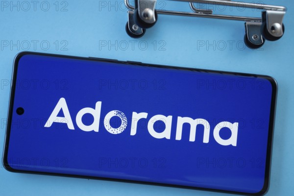 Dhaka, Bangladesh- 03 July 2025: Smartphone screen showing the Adorama logo with shopping cart wheels on a blue background
