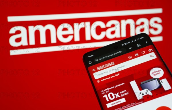 Dhaka, Bangladesh- 03 July 2025: Smartphone displaying Americanas web interface against americanas logo background