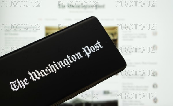 Dhaka, Bangladesh - 18 March 2025: The logo of the wall street journal is displayed on a smartphone screen, and the website is visible on a computer screen in the background