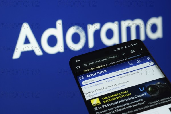 Dhaka, Bangladesh- 03 July 2025: Smartphone displaying Adorama web interface against adorama logo background