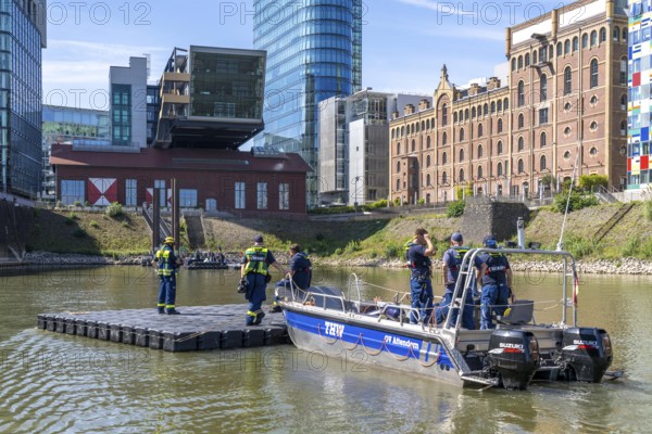 Transport of a floating platform with the jet-float system, this can be used as a work platform, jetty or bridge, specialist group for water hazards, in Düsseldorf, during the major exercise FÜLEX25, lasting several days, of the THW, Federal Agency for Technical Relief, North Rhine-Westphalia, over 3500 volunteers from the 127 North Rhine-Westphalia local organisations practise many different deployment scenarios over 4 weekends