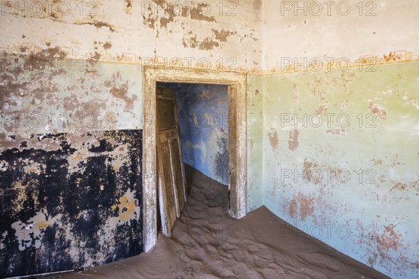 At Kolmanskop, the abandoned ghost town of the diamond days of the early 1900 and of German origin. Inside the restricted Diamond Area east of the coastal town of Lüderitz. Namib Desert, Namibia