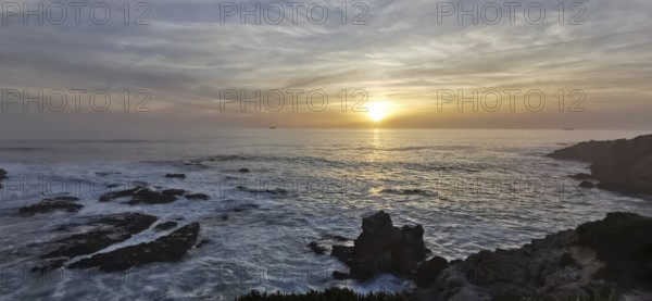 A breathtaking sunset over a rocky and wild coast, hiking the Fisherman's trail, Rota Vicentina, Porto Covo, Alentejo region, Portugal