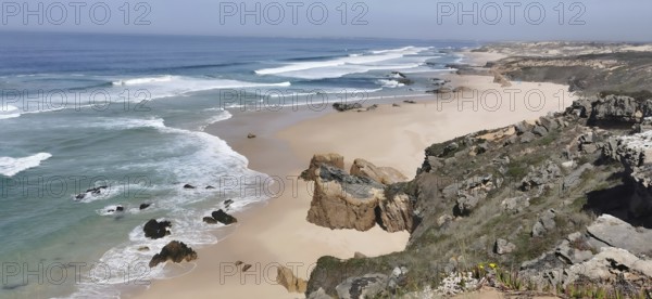 Rocky cliffs border an extensive sandy beach by the sea, hiking on the Fisherman's Trail, fishing trail, Rota Vicentina, Portugal