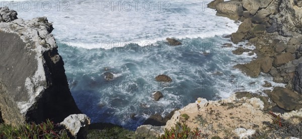 Turquoise waves crashing against rough cliffs by the sea, hiking the Fisherman's Trail, fishing trail, Rota Vicentina, Portugal