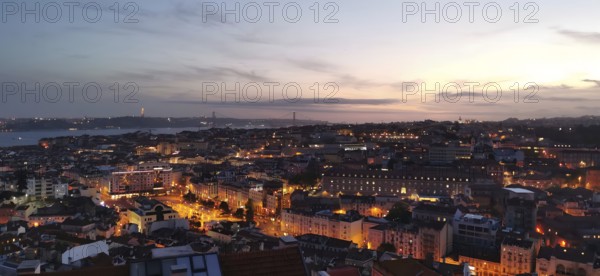 Panoramic view of Lisbon, city view with illuminated streets and buildings under a twilight sky, Lisbon, Portugal