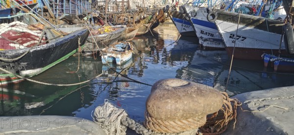 Colourful fishing boats moored in port, with ropes and calm water, Essaouira, Morocco