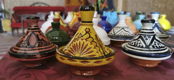 Colourful ceramic tajines in traditional Moroccan designs on a table, Morocco