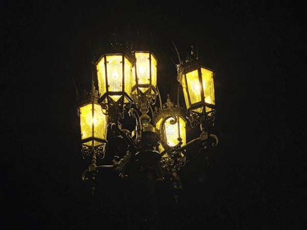 Glowing nostalgic street lamp at night creates a cozy atmosphere, Dresden