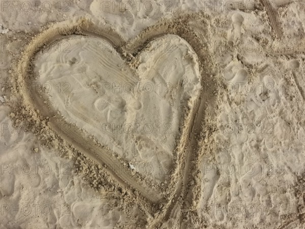 Heart drawn in sand on a beach