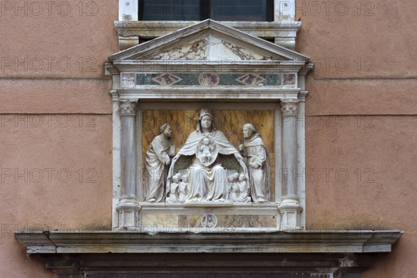 Sculpture of the Madonna of the Virgin Mary holding the faithful under her spread cloak, Madonna dell'Orto parish church, Venice, Veneto, Italy