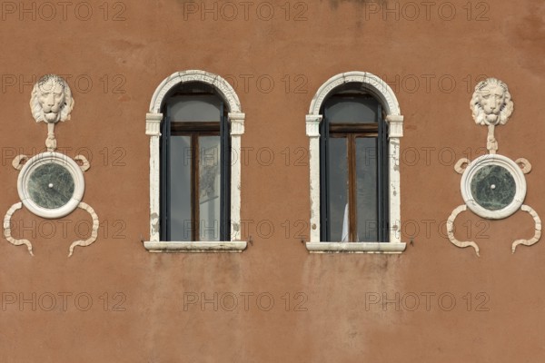 Sculptures of lion heads on a house wall, Venice, Veneto, Italy
