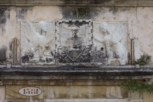 Relief over an entrance valley, two hybrid creatures, chimeras holding a coat of arms, Venice, Veneto, Italy