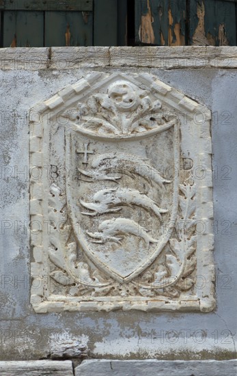Coat of arms with three dolphins on a house wall, Venice, Veneto, Italy