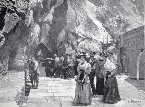 Day trippers at the end of the Tamina Gorge in front of the entrance to the spring, part of the Tamina Valley in the canton of St. Gallen in Switzerland, authentic, digitally restored reproduction from a 19th century model, exact date of depiction unknown, historical, historical scene of people in traditional clothing exploring a rocky environment