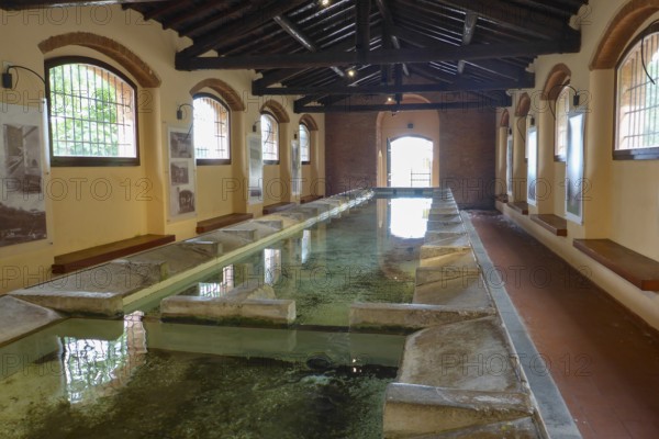 Historic wash house public washing place (Lavatoio) of Rio nell'Elba with running water and 18 self-cleaning tubs for washing clothes, Elba Island, Tuscany, Italy
