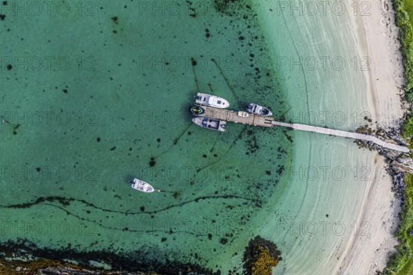Leisure boats at the jetty, sandy beach, island Sommaroy, top down aerial view, Norway
