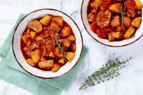 Meat goulash with potatoes and carrots, sweet peppers, in a saucepan, top view, traditional Hungarian soup, homemade, no people
