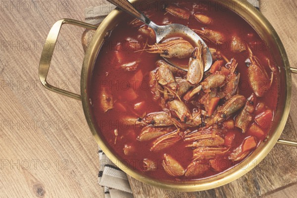 French shrimp bisque soup, in a pot, close-up, no people