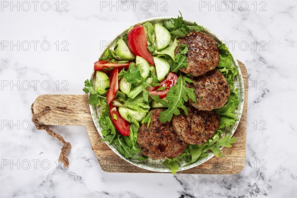 Fried cutlets, mixed minced meat, with vegetable salad, homemade, top view, no people