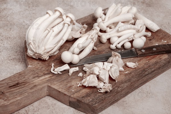 Freshly sliced Shimizhi mushrooms, on a wooden chopping board, ready to cook, close-up, no people