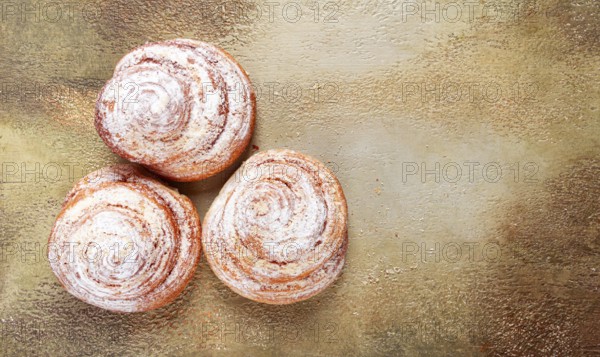 Bakery product, lemon twist, with white glaze, sweet bun, muffin, pastries, top view, no people