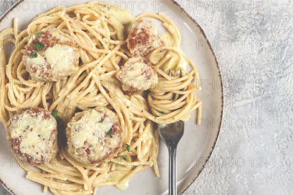 Spaghetti with chicken meatballs, with cream sauce, and parmesan cheese, and decorated with microgreens, homemade, no people