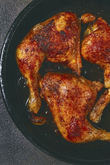 Baked chicken legs, with crispy skin, served in a pan, rustic style, homemade, no people