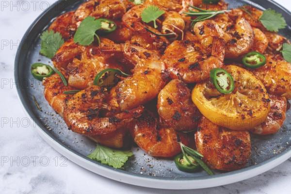 Grilled shrimp, unpeeled, headless, with spices, on a marble table, homemade, no people