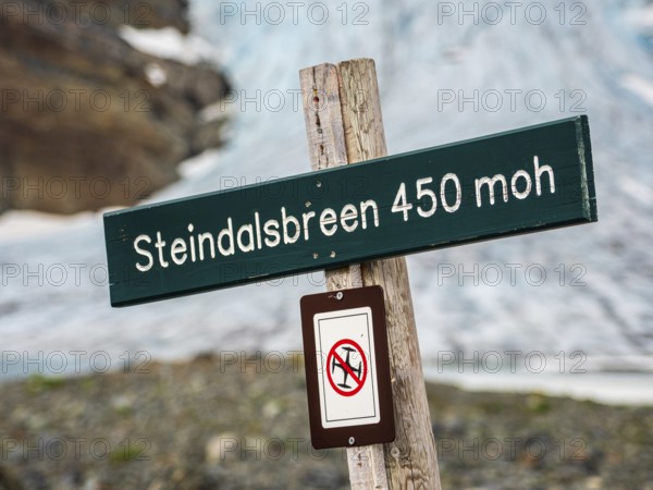 Signpost at glacier Steindalsbre, drones prohibited, Lyngen Alps, Norway