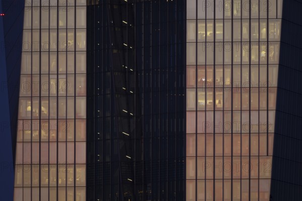 The setting sun shines on the glass façade of the European Central Bank (ECB) in Frankfurt am Main, Frankfurt am Main, Hesse, Germany