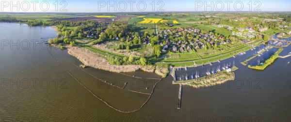 Stitched Panorama A village weekend house settlement Holiday homes with marina and fields surrounded by a lake, from a bird's eye view, Dümmer nature park Park, Lembruch, Lower Saxony, Germany