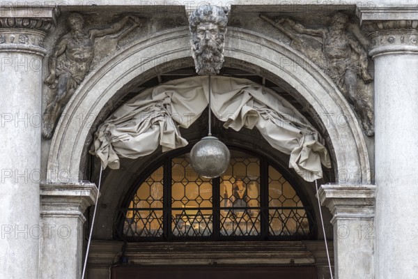 Sculptures on the round arch of the arcades in St. Mark's Square, Venice, Veneto, Italy