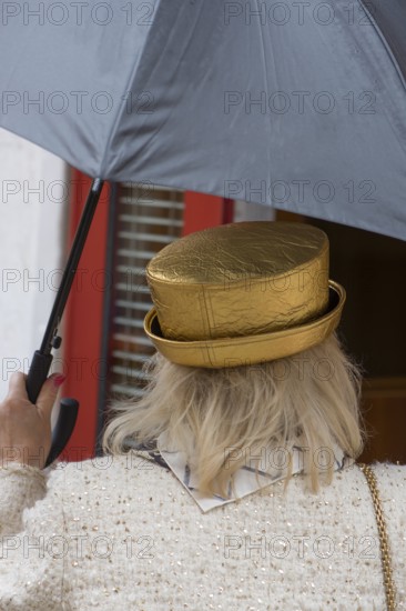 Woman with umbrella and golden hat, Venice, Veneto, Italy