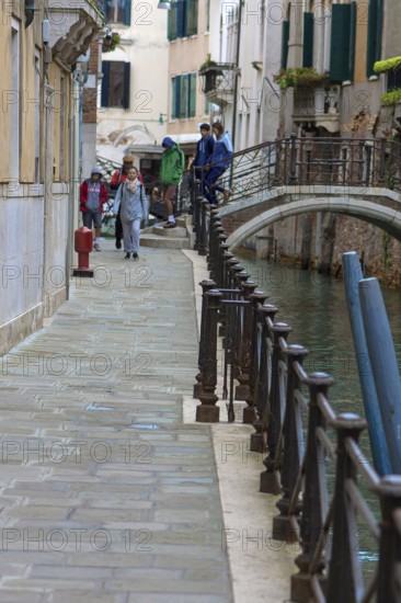 Pedestrian path along the canal with railing, Venice, Veneto, Italy