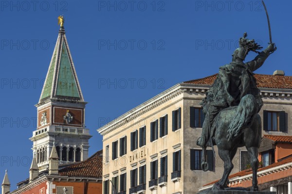 Spire of St. Mark's Campanile, in front the equestrian statue of Victor Emmanuel II, 1820-1878, blue sky, Venice, Veneto, Italy