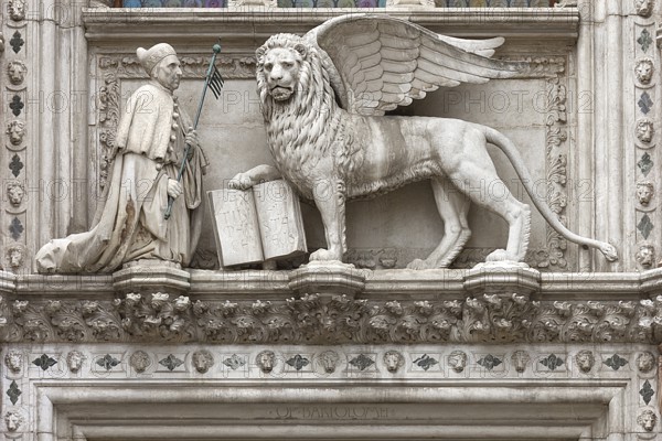 Doge kneels in front of St. Mark's Lion above the Porta della Carta of the Doge's Palace, Venice, Veneto, Italy
