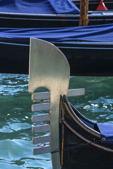 The metal tail of a gondola with six points symbolizing the six districts of Venice, Venice, Veneto, Italy