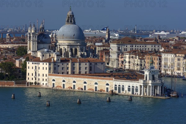 Santa Maria della Salute church, Museum of Modern Art in front, cruise ships anchored at the back, blue sky, Venice, Veneto, Italy