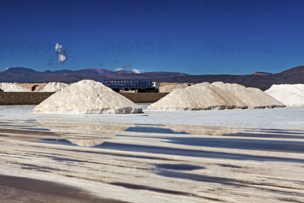Salt heaps and industrial plants under a blue sky in a desert-like landscape, The Salar de Cauchari salt pan near Salta in Argentina